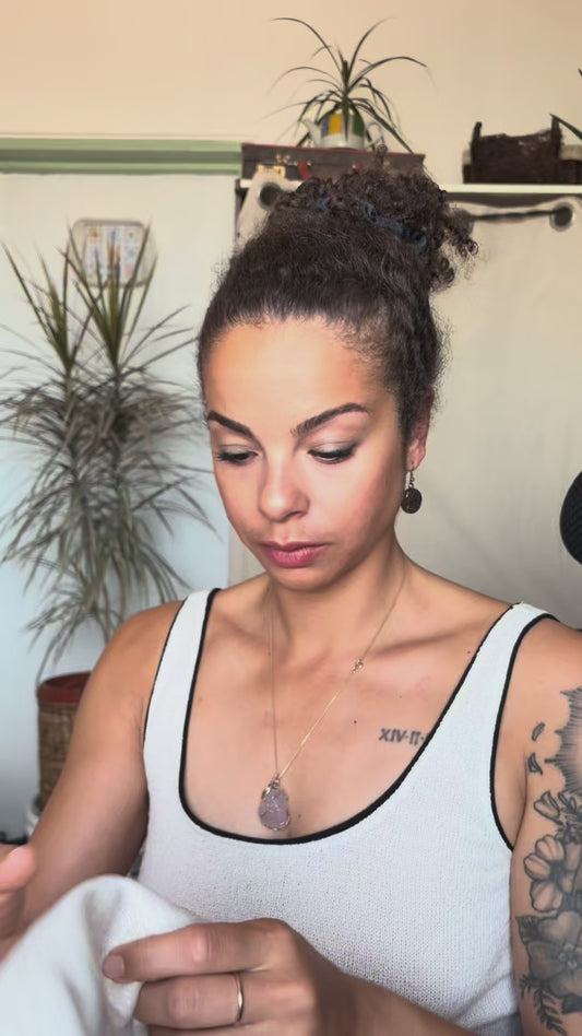 Video of a woman putting on the Kim K Crown, a reversible cream metallic hair turban